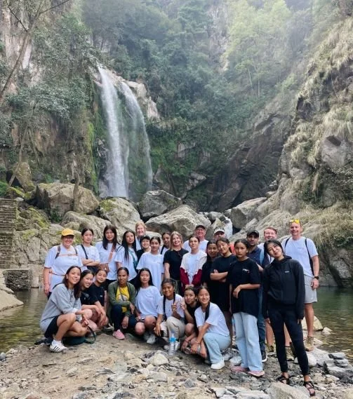 Students participating in Hero Camp activities in Nepal. Enjoying a hike to a beautiful waterfall.