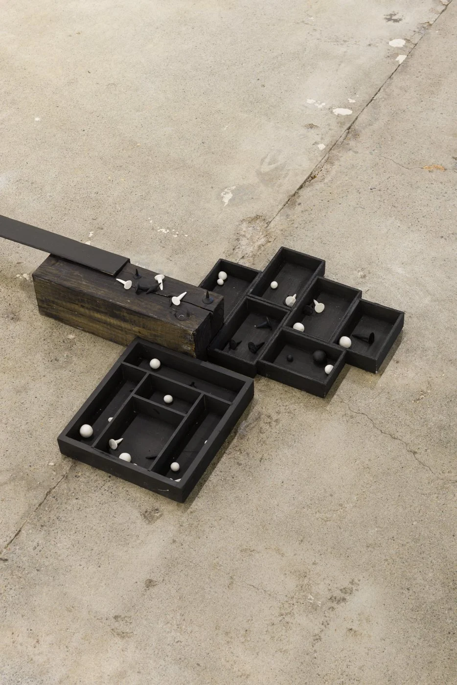   Coming Together, Falling Apart | 2022   Lumber, cardboard shipping corners, hardware, canvas, house paint, acrylic paint, foam core, MDF, sculpey, ceramic, scrap wood, futon frame slats, wood shims, existing steel beams of gallery. 