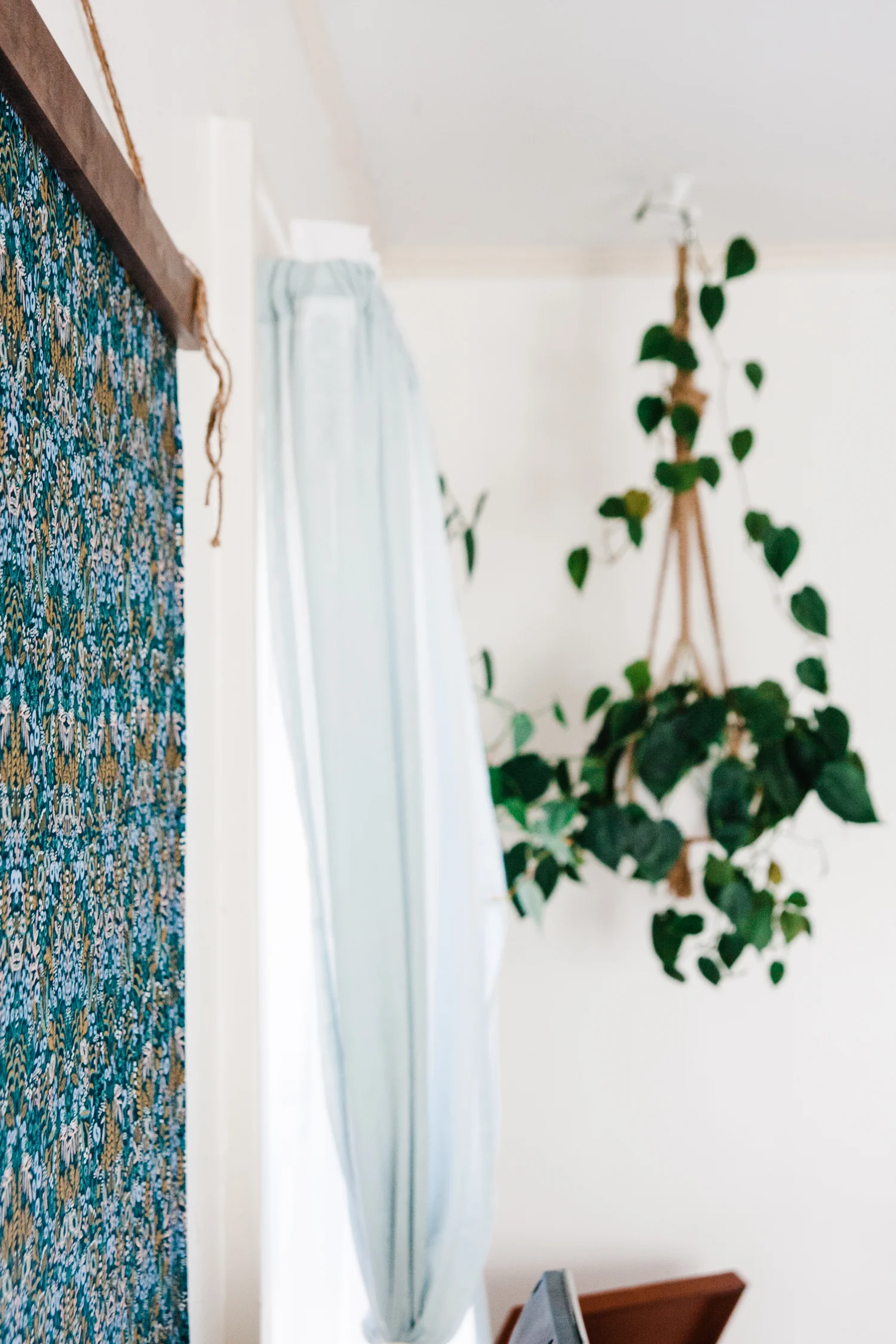 Rifle Paper Co fabric from Owl & Drum hangs on the living room wall from a simple wooden frame Emily DIYed.