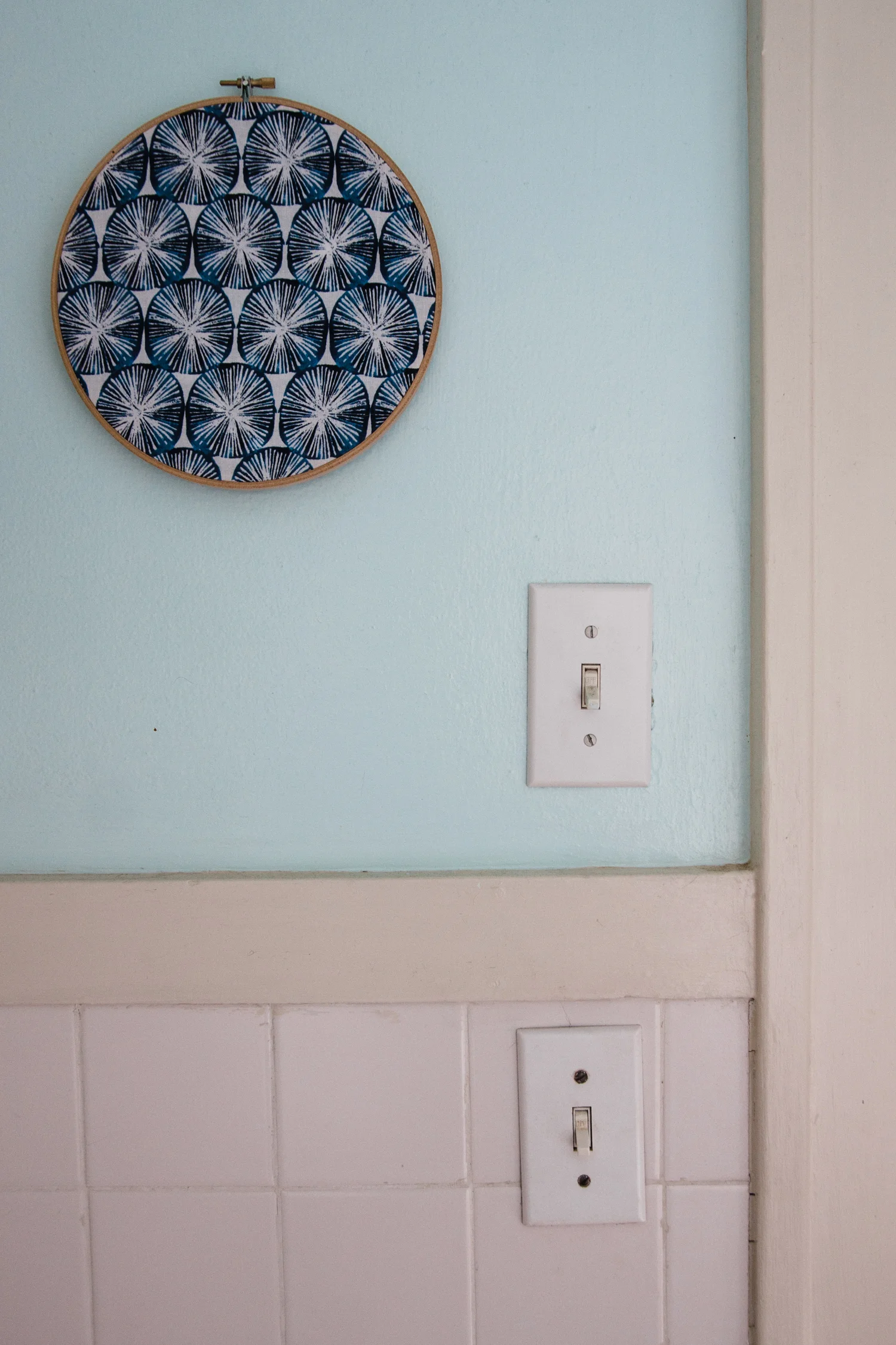 Emily uses Owl & Drum fabric in an embroidery hoop as artwork in her bathroom.