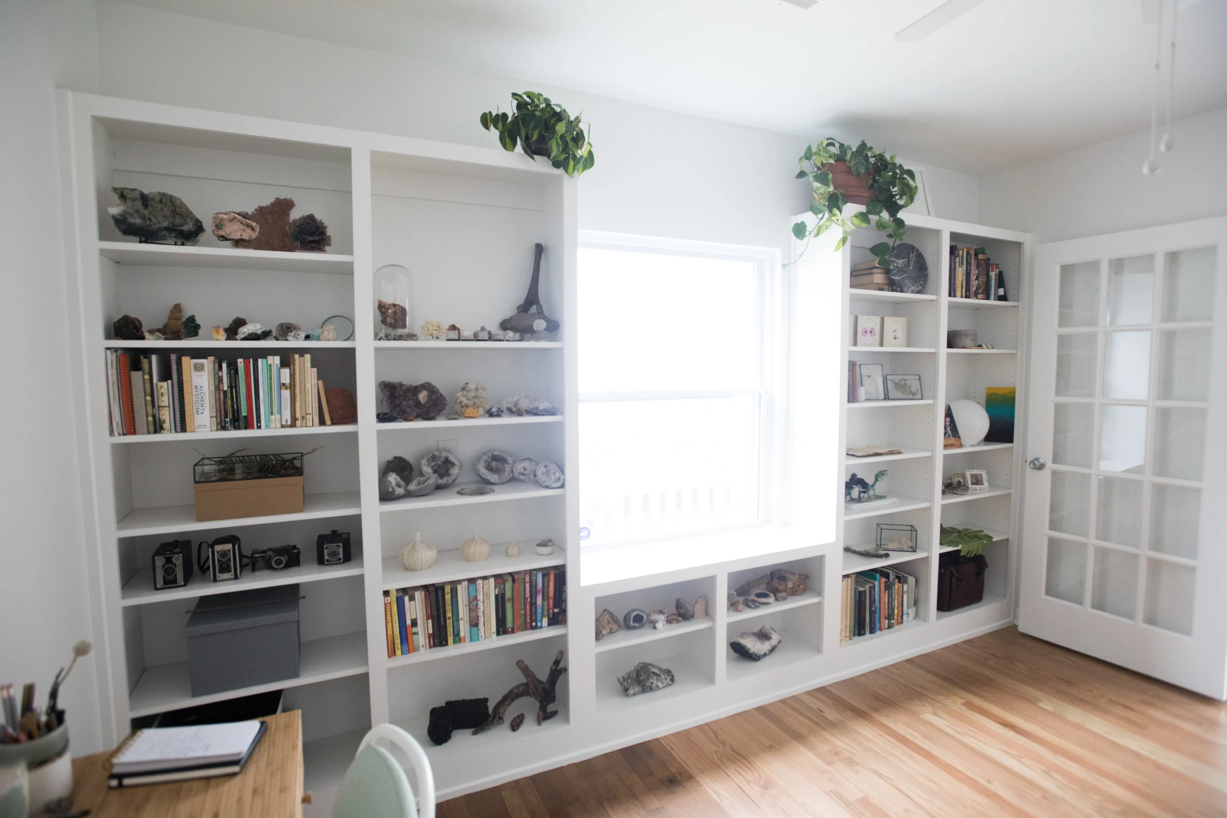 Tyler displays his collections and work specimen on the built-in shelving the couple added after the fire.