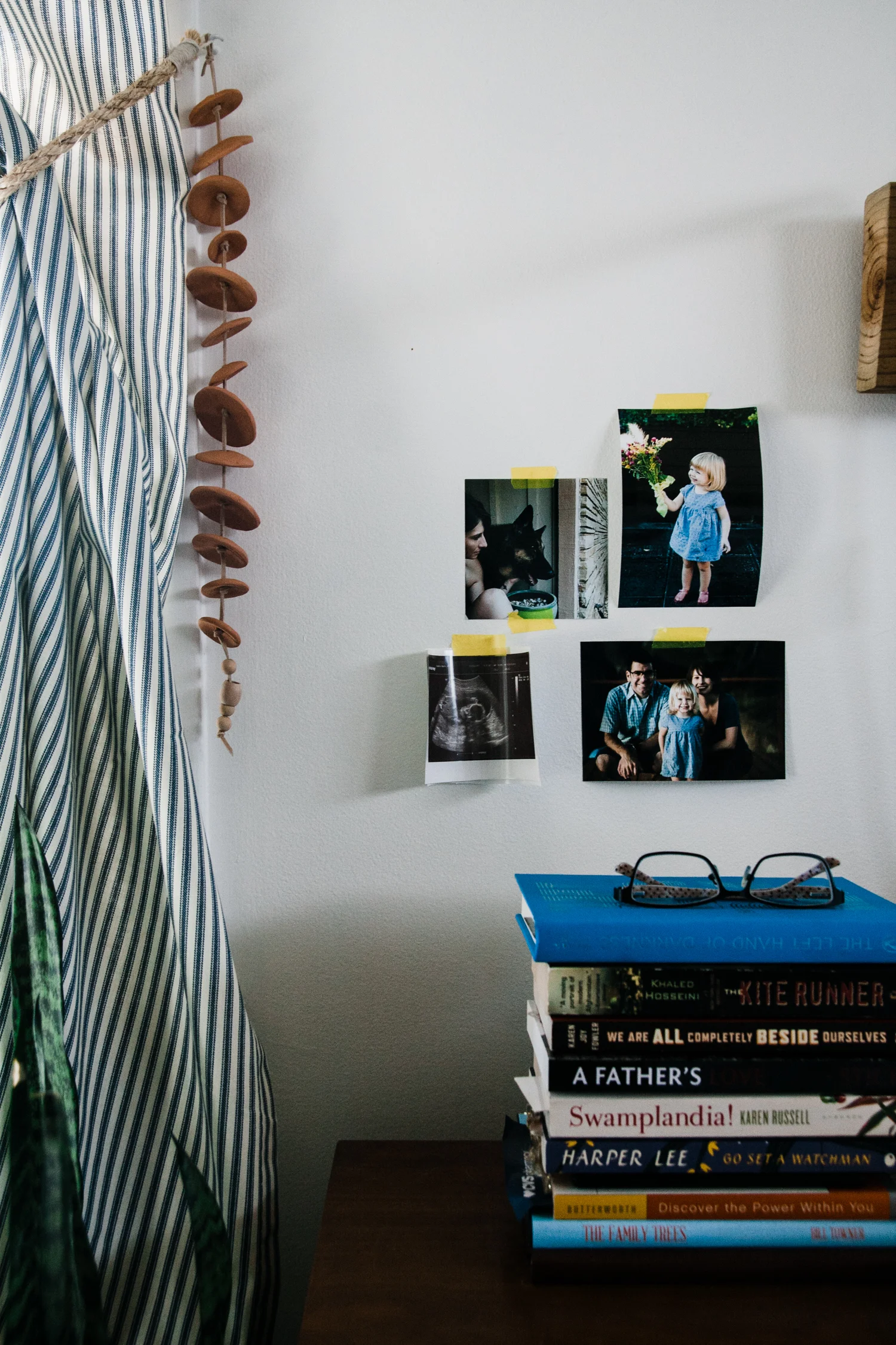 I tape up family photos near my bedside.