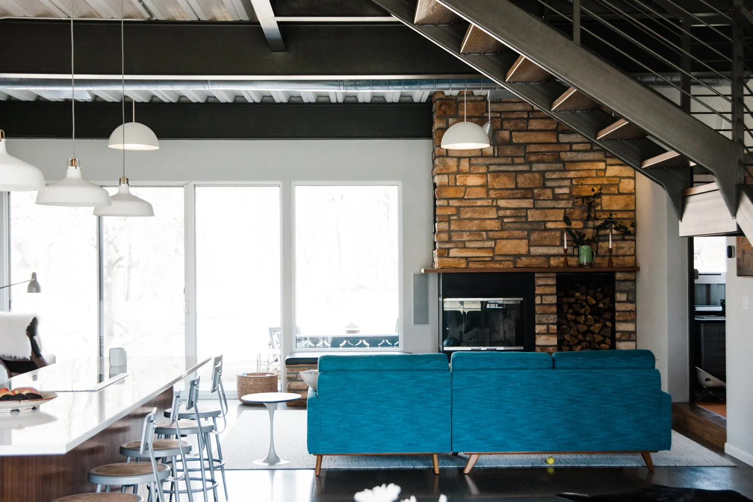 The TV is tucked away behind the stone fireplace and can slide out when needed.