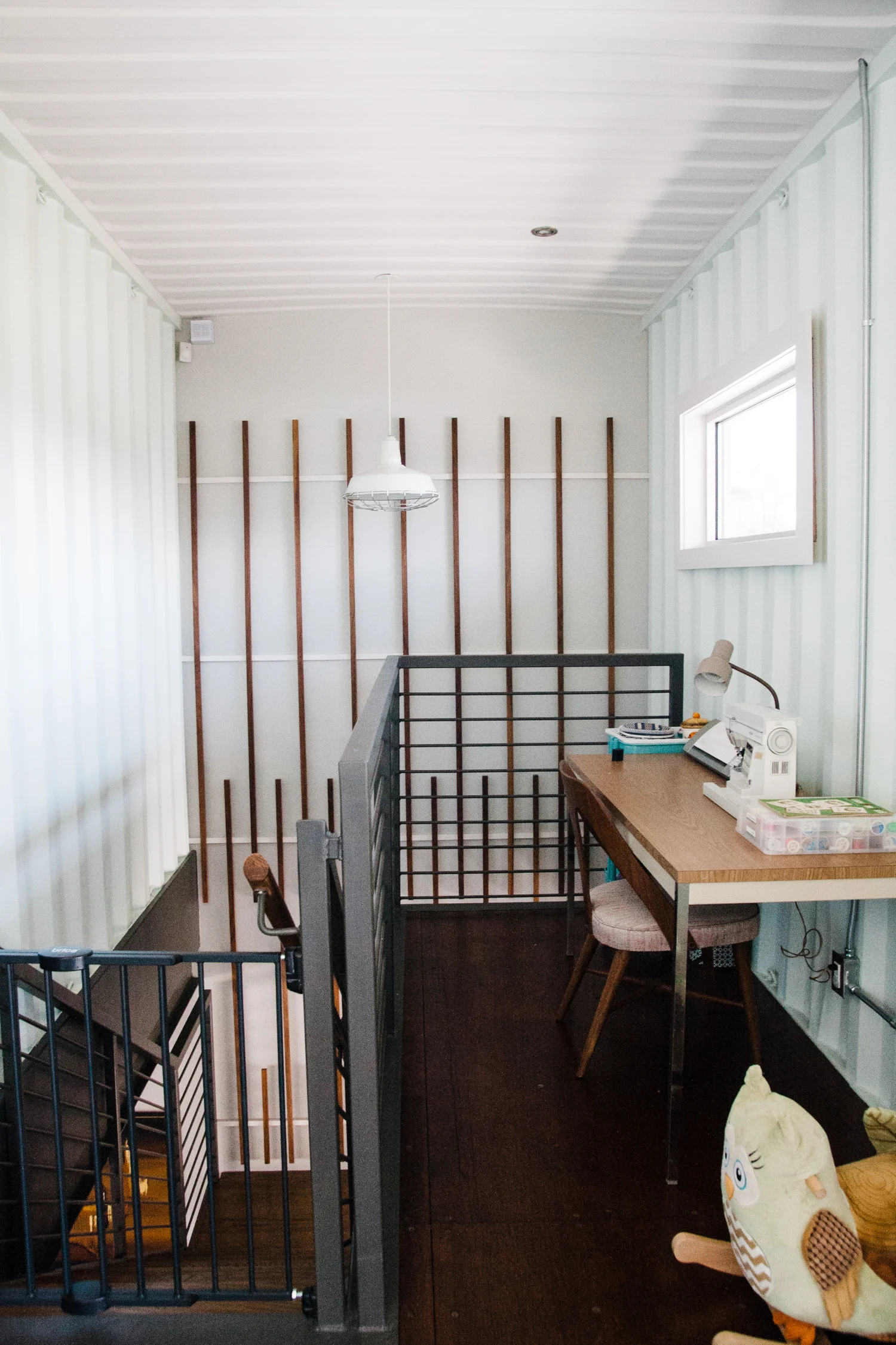The Brights added the vertical wood pieces to the wall for both form and function. Also, Hannah inherited the sewing machine and is planning to spend more time on her creative hobby.