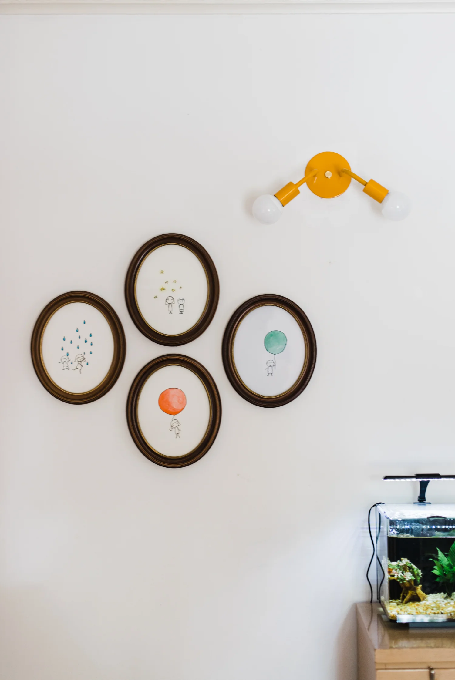I moved the Caroline series of artwork that I drew when I was pregnant with Caroline to another wall and added Jack to the mix. For some strange reason, I had saved the fourth oval frame in a closet for four years not knowing why. Well, now I know why. 
