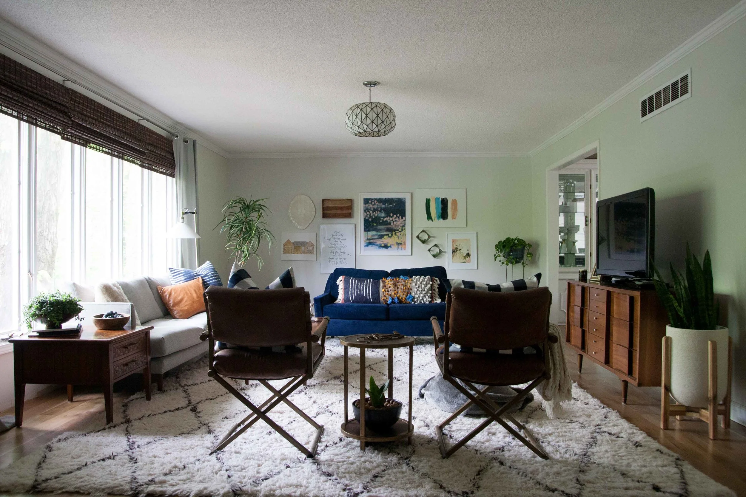 Ashley from the home and lifestyle blog Bigger Than the Three Of Us , used mostly white frames for her living room gallery wall. The colorful artwork really stands out with this streamlined choice.