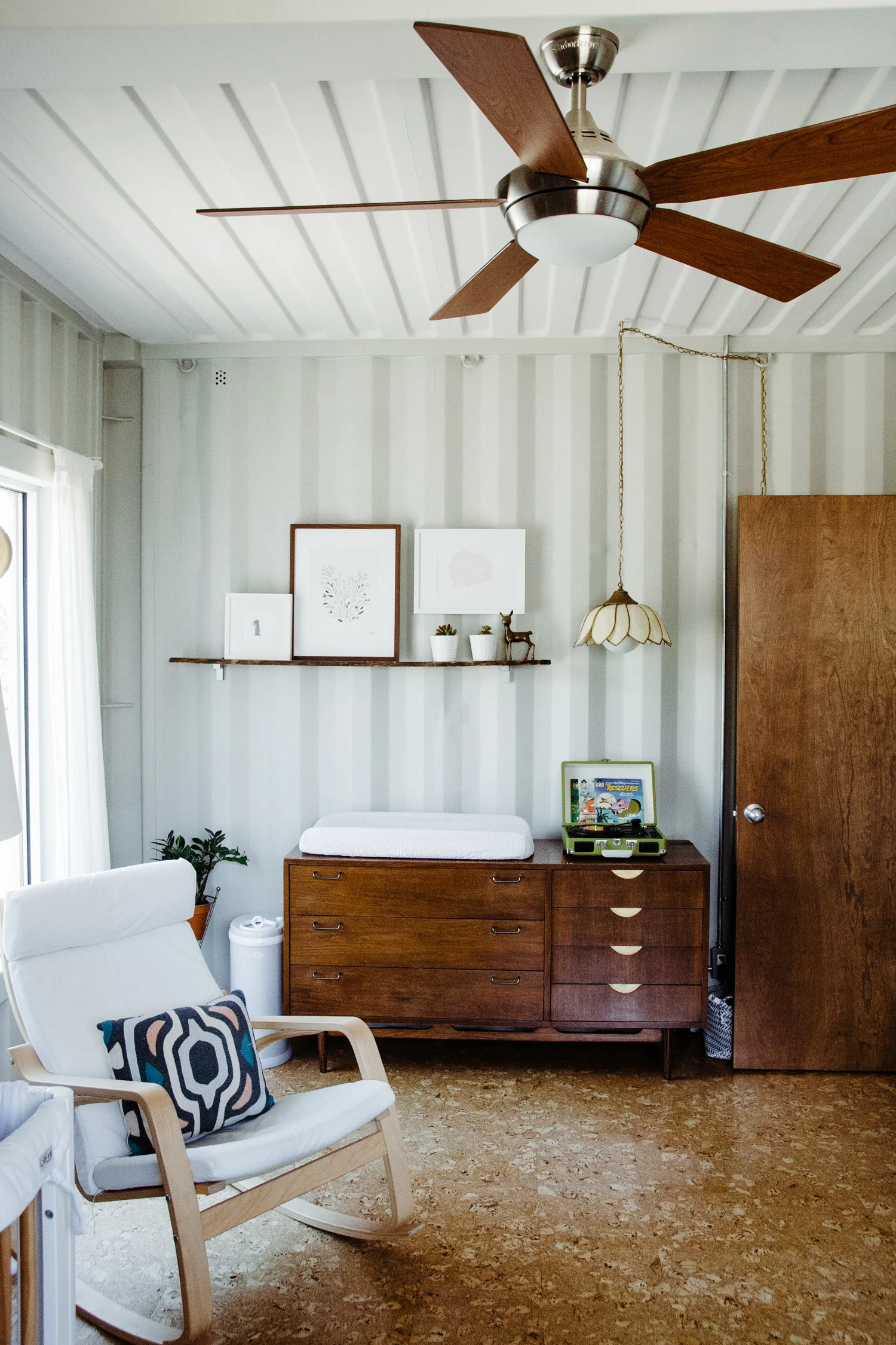 Hannah Bright used both white and dark wood frames in her daughter's room . All of the frames are streamlined, simple, and call out to other wood and white objects in the room (white crib, wooden dresser, white rug, etc.).