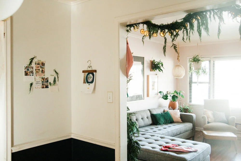I used washi tape to hang the holiday cards we received into an increasingly Christmas tree type shape, and I added some twigs from our Christmas tree to make it a tad more festive.