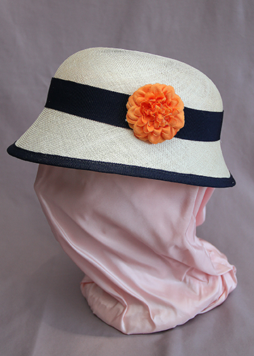 Cream sinamay close with navy trim and orange fabric flower