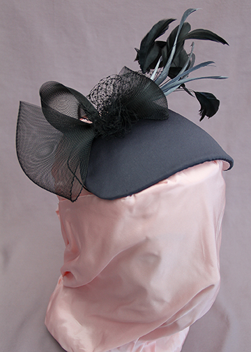 Cocktail hat covered in steel gray fabric with feathers and horsehair trims