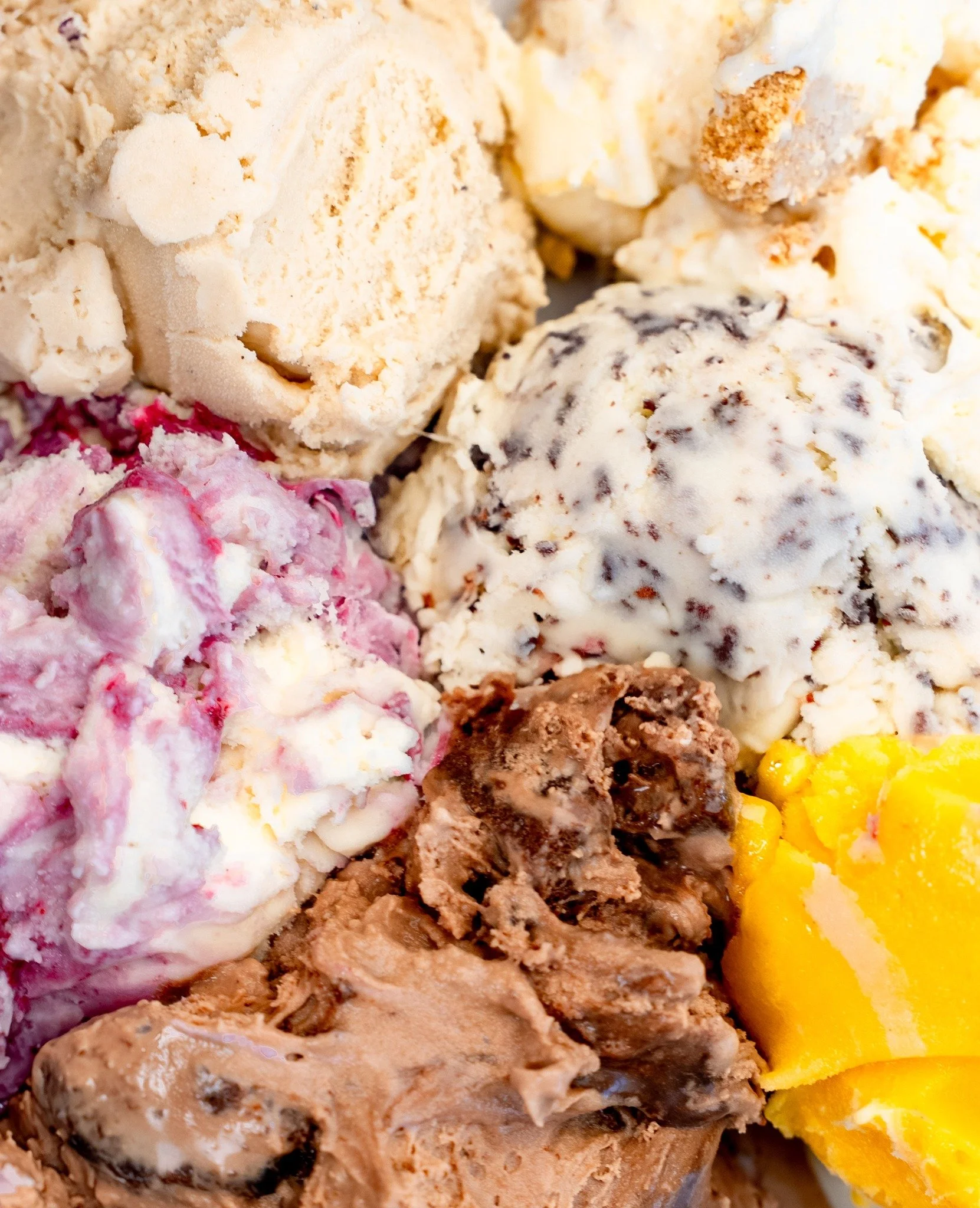Close-up of various scoops of different flavors of ice cream.