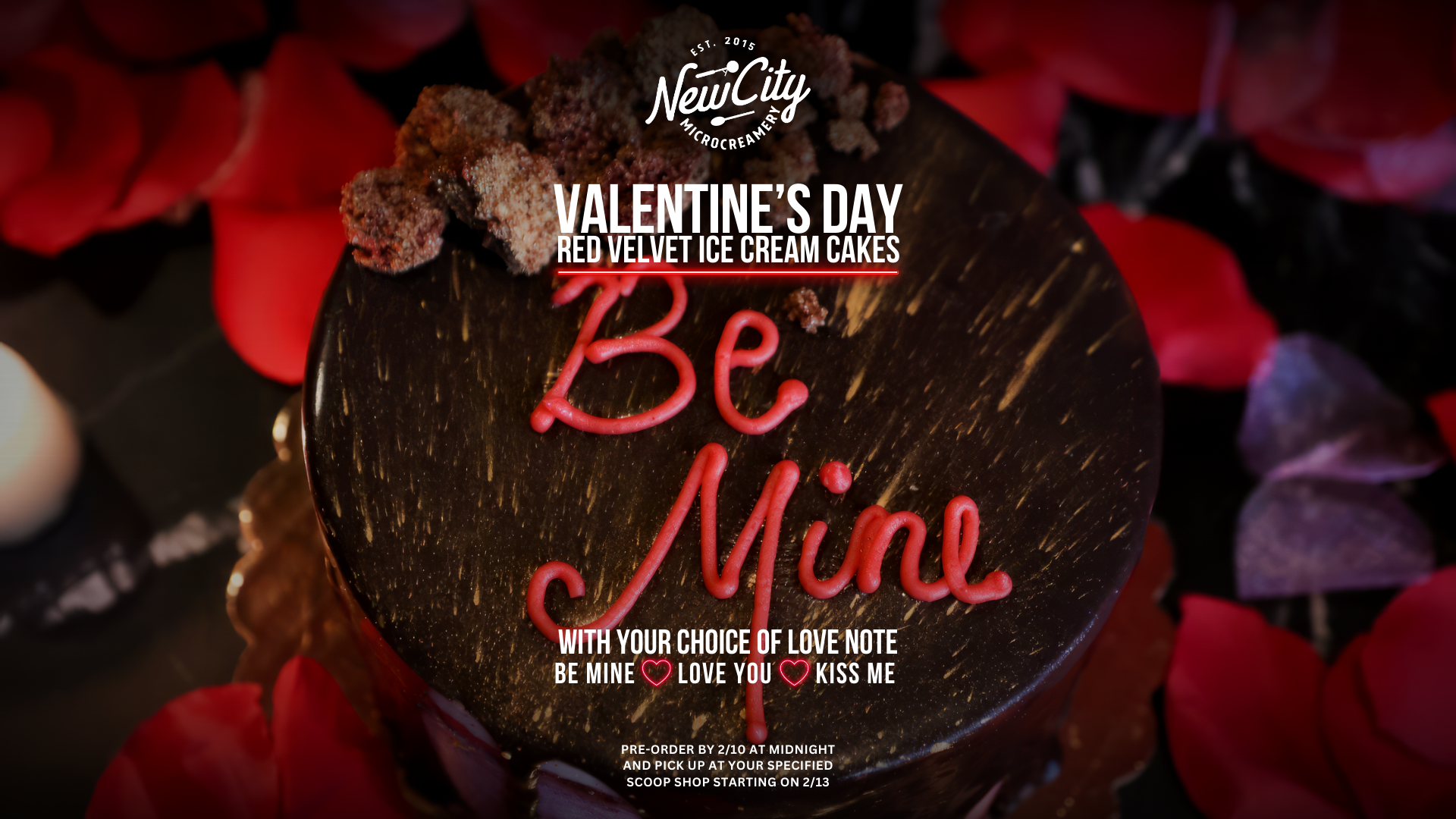 A Valentine's Day cake decorated with red icing words 'Be Mine' surrounded by red and purple rose petals, with a chocolate glaze and crumbled cake topping.