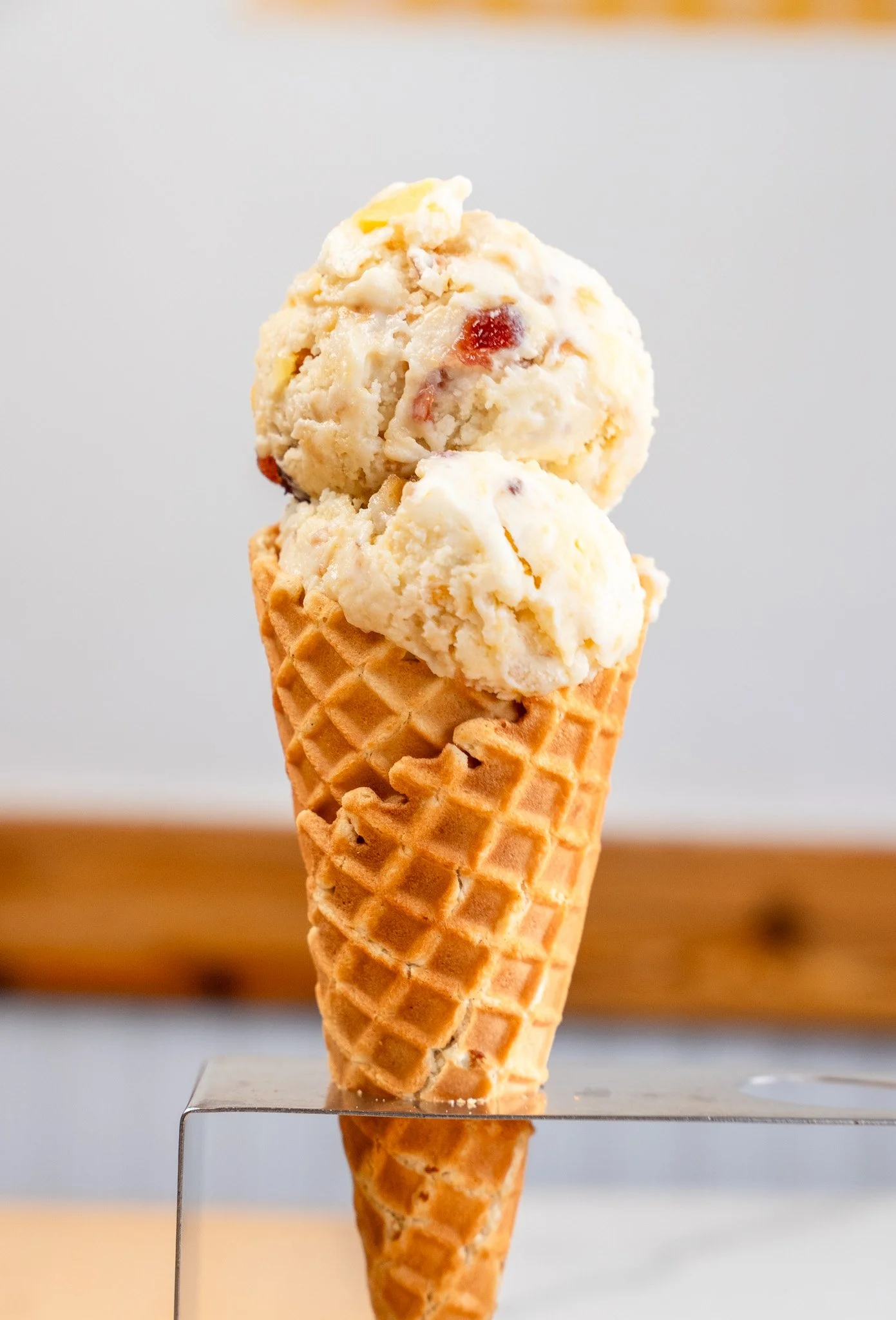 Two scoops of ice cream in a waffle cone