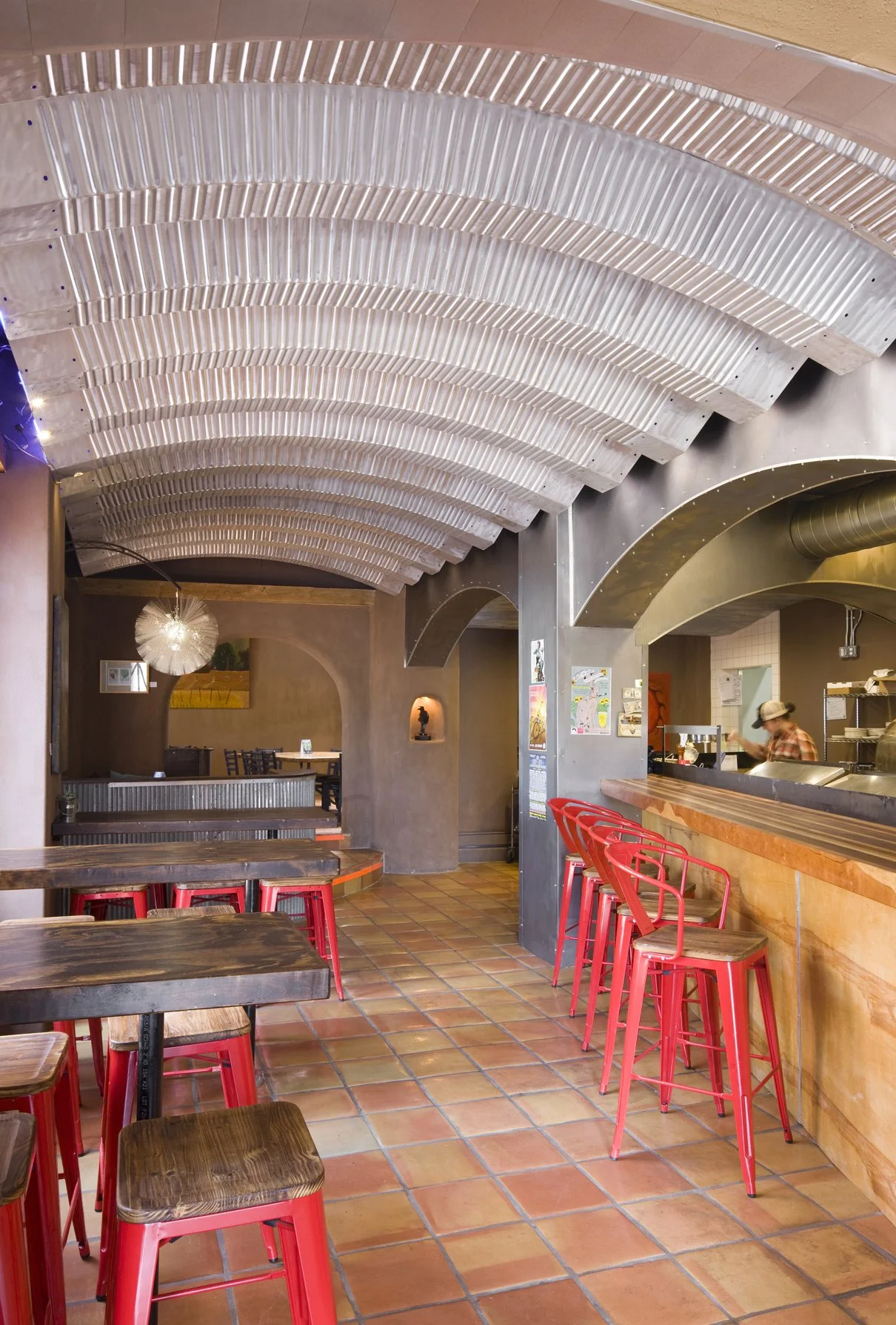 Arched steel ceilings and kitchen windows contribute to ultra-cool industrial ambiance 