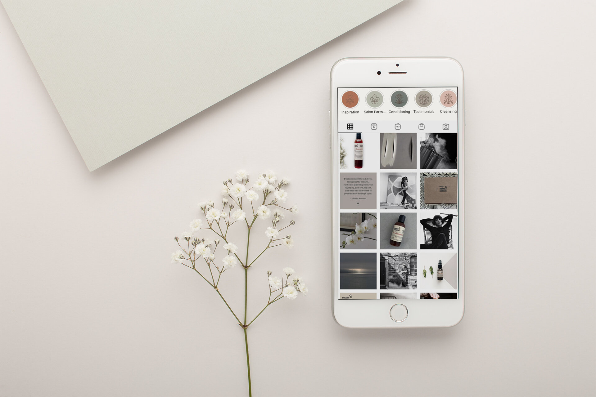 silver-iphone-mockup-lying-next-to-small-white-flowers-22019.02.jpg
