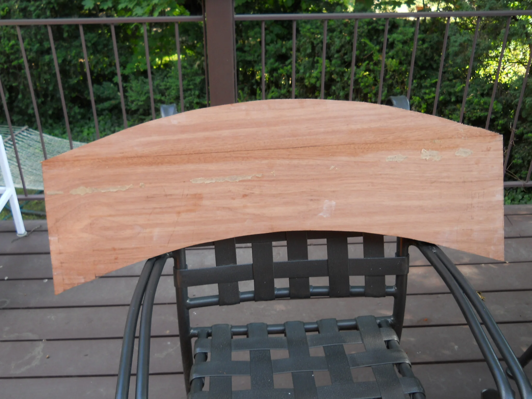  I wanted to create a piece that had an overall arc so I started by cutting an arc out of the bottom and gluing it to the top. You can see the glue line. This piece is 1" thick mahagony, about 36" wide by 14" high. 