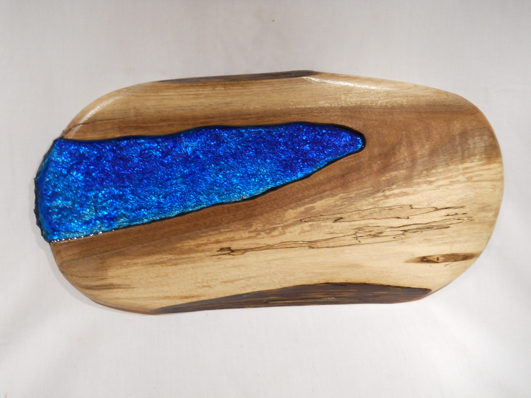  Spalted maple with blue intrusion 18" x 9". This beautiful slab, with a live edge on the bottom, is from a big, old maple tree that fell in a storm and lay in the woods for a year before I came upon it. 