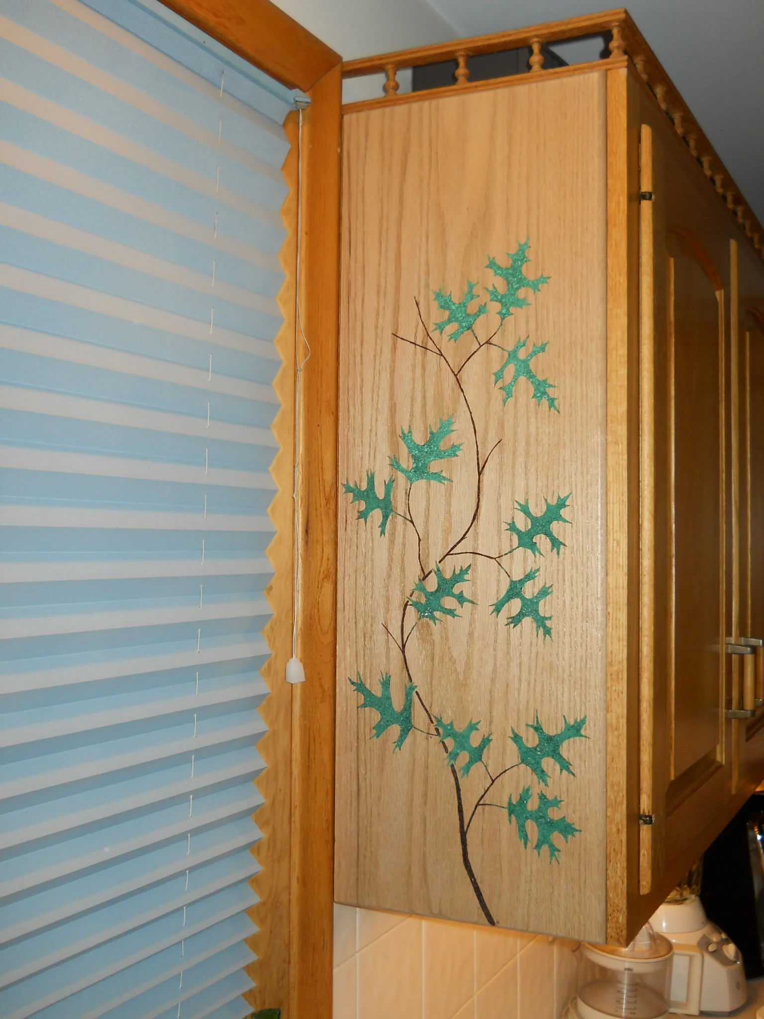  The oak leaves on this cabinet end are malachite, inlaid into the wood.&nbsp; 