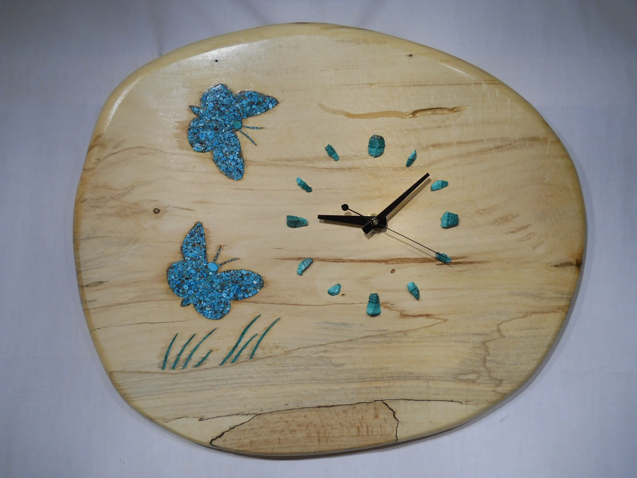  This beautifully spalted maple slab calls to mind the American southwest. &nbsp;The inlaid butterflies are turquoise and the clock marks are chunks of solid malachite. I use clock movements with sweep second hands which means there is no ticking sou