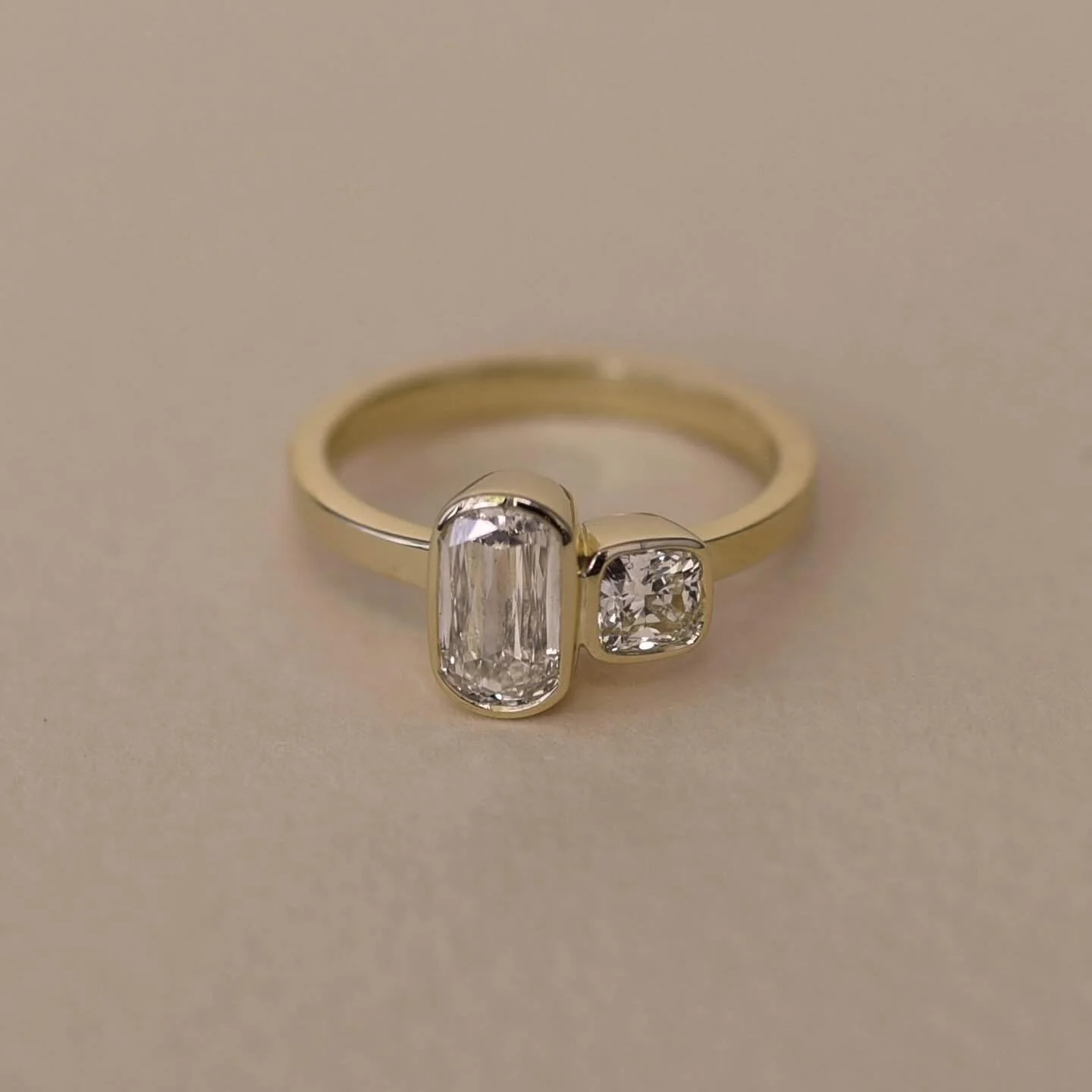 A very cute engagement ring for Janelle! We used warmer natural diamonds for this one &mdash; a bezel set crisscut and a square cushion 😍