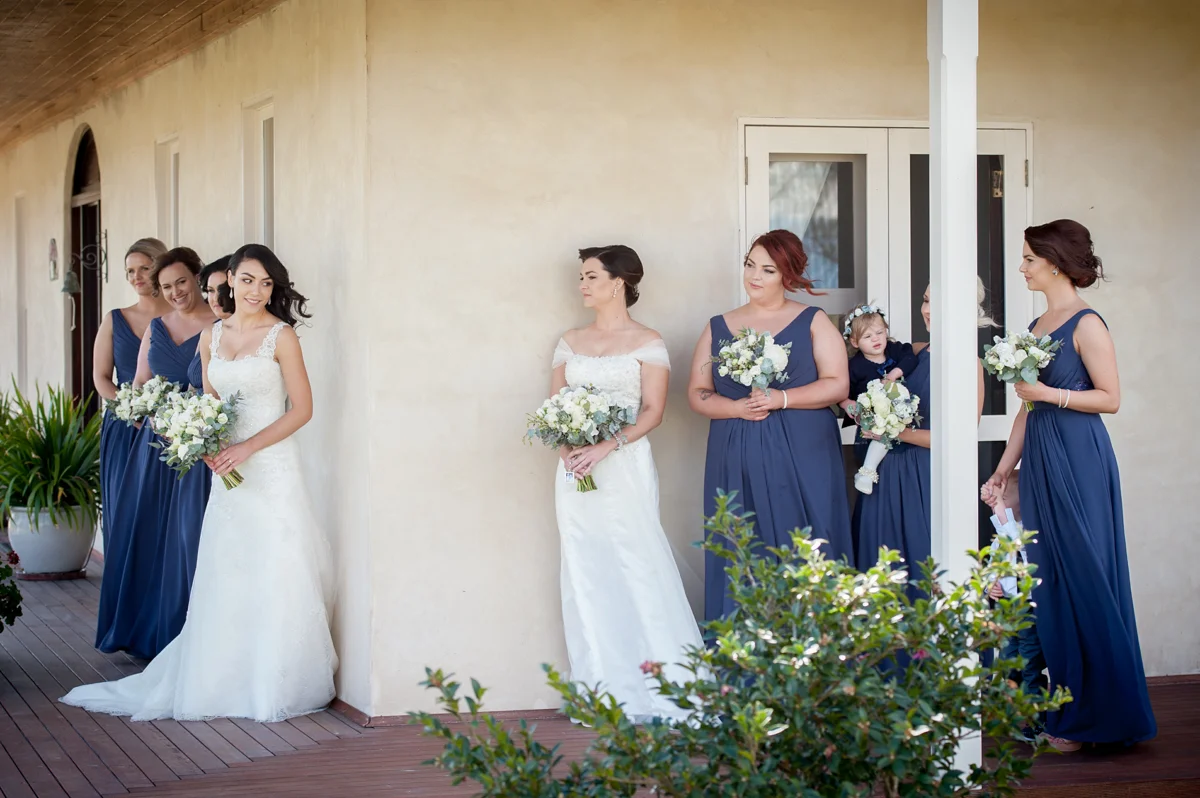 Commitment ceremony couple hold hands at Calvin Estate