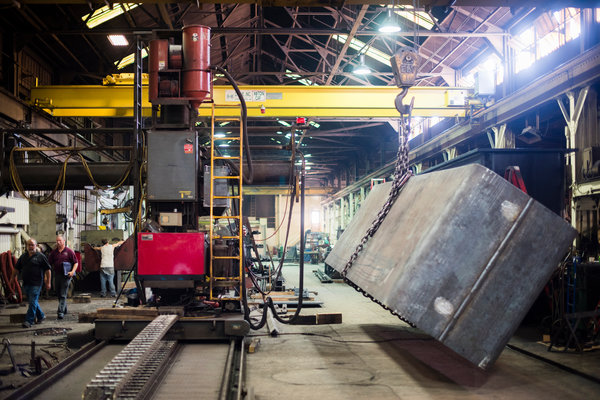 Steel weighing about 30,000 pounds is lifted by a crane at Columbiana Boiler. “If something goes wrong, it won’t hurt our workers. It’ll kill them,” Mr. Sherwin said. “And that’s why we can’t take any risks with drugs.”