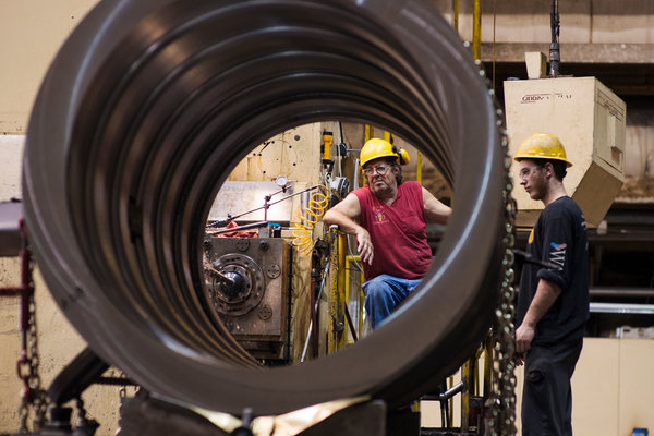 At Warren Fabricating & Machining in Hubbard, Ohio, an apprentice, Andrew DeMattia, right, observed as a machinist, Paul Wysenski, worked on a generator component.