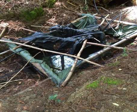 Fertilizer seen in a makeshift pond with irrigation hoses attached in order to funnel water to grow sites in Mendocino County is California, pictured in this undated handout photo obtained by Reuters July 25, 2017. California Department of Fish and Wildlife/Handout via REUTERS