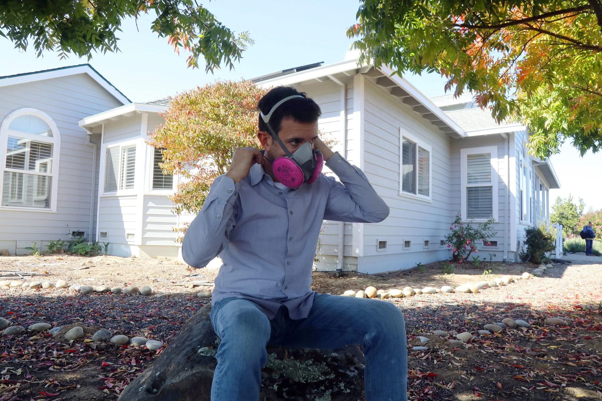 Robert Guthrie wearing his respirator outside his home in Sebastopol, Calif. “I can’t be outside more than 30 minutes,” Mr. Guthrie said of peak cannabis odor times .Credit Jim Wilson/The New York Times
