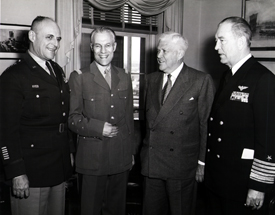 General Matthew Ridgway asks Secretary Wilson to remove the knife from his back...Pictured: GEN Matthew Ridgway, French GEN Paul Ely, Secretary of Defense Charles Wilson and ADM Arthur Radford, 22 March 1954 (Public Domain).
