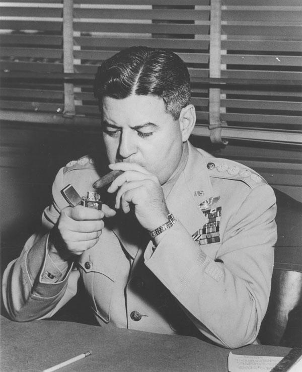 Curtis LeMay at the height of his power in 1957, lighting his ubiquitous cigar with all the money he scored the Air Force. (Image: NSA Archive, GWU University - Public Domain).
