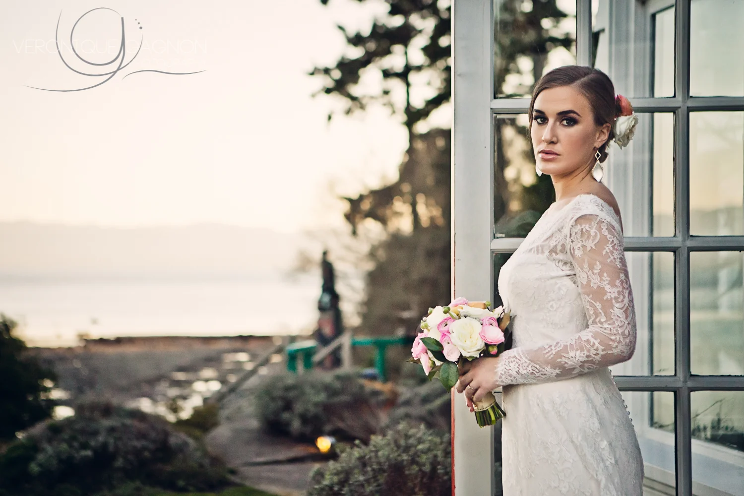 Marjorie wearing a beautiful lace wedding gown from Blush Bridal boutique in Victoria and stunning Leah Alexandra earrings from Violette boutique .