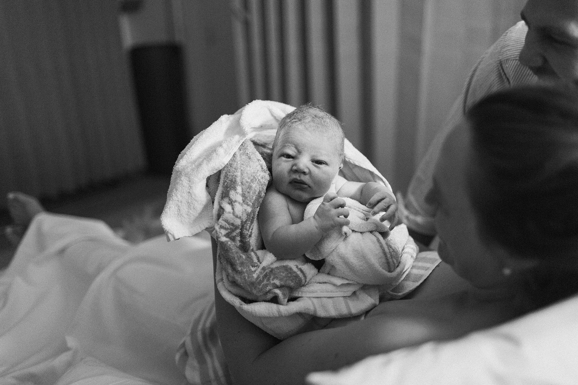 A newborn baby boy — brand new and already full of curiosity about the big bright world he’s entered.