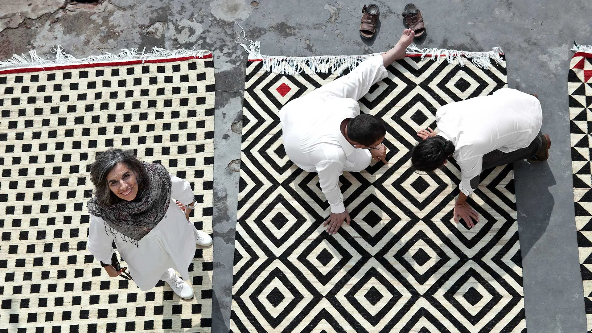 Head designer, founder and namesake Nani Marquina with some of the craftsman behind her rugs.