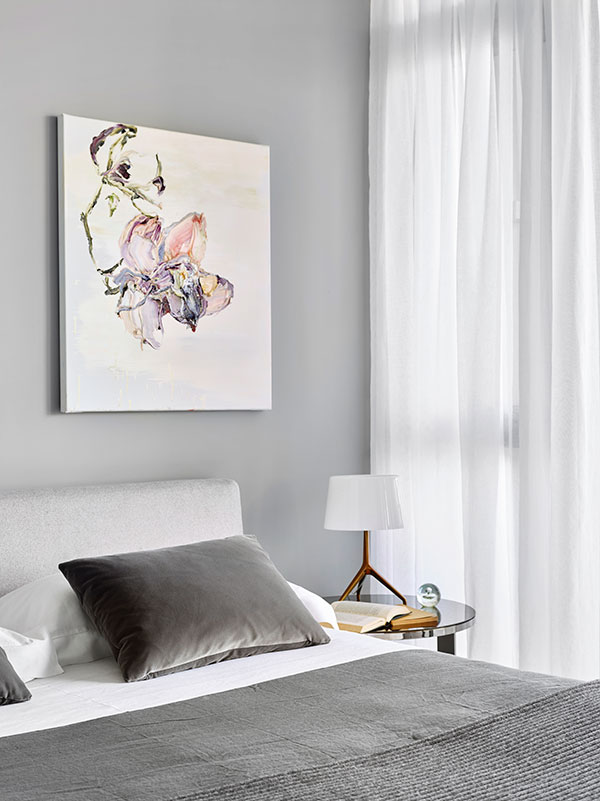 B&B Italia Charles bed and F oscarini Lumiere XXS table lamp with bronze base and white shade.