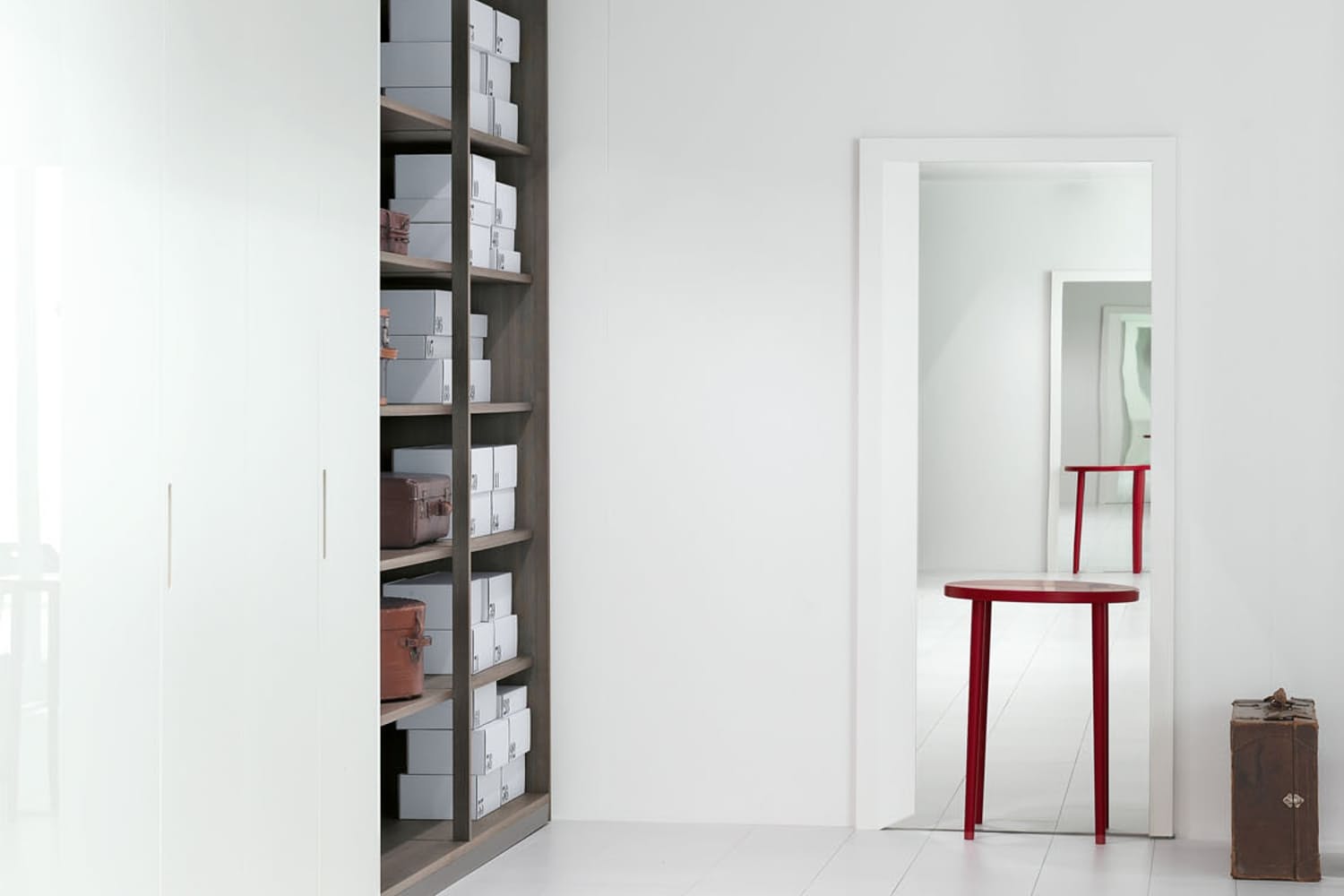 Porro's Mirror Table could be a functional and interesting addition to a bedroom. The rectangular mirror with frame incorporates a wooden console table, a shelf designed for placing small objects on, which, when reflected in the mirror, creates the deceptive image of a round table. 
