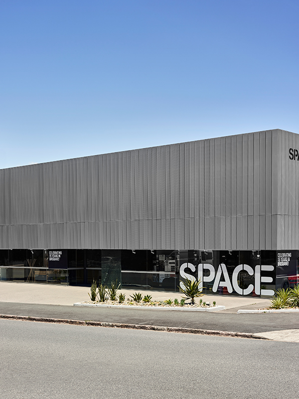The exterior ‘veil' is made of aluminium, with a continuous face of shopfront glazing behind that's a giant window into the Space collection. Photo: Toby Scott