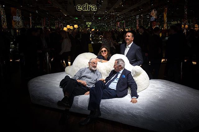 Designer Francessco Binfaré (left) reclining on his new Pack and Chiara sofa at the Edra installation during the Milan Furniture Fair this year. 