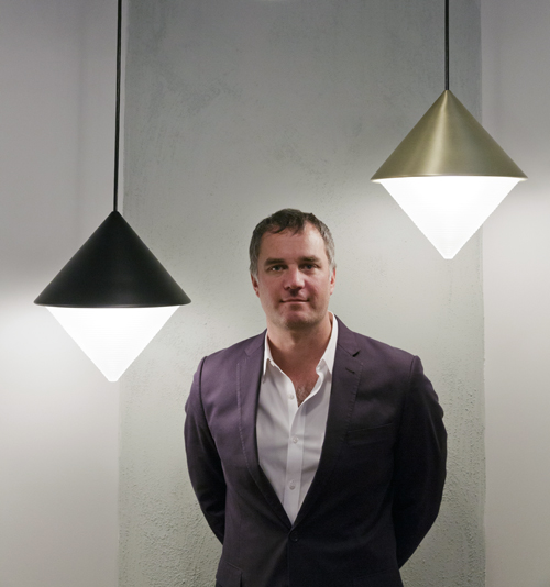 Roll & Hill founder and designer Jason Miller, photographed with the Half and Half Pendent designed by Jonah Takaji and Hallgeir Homstvedt