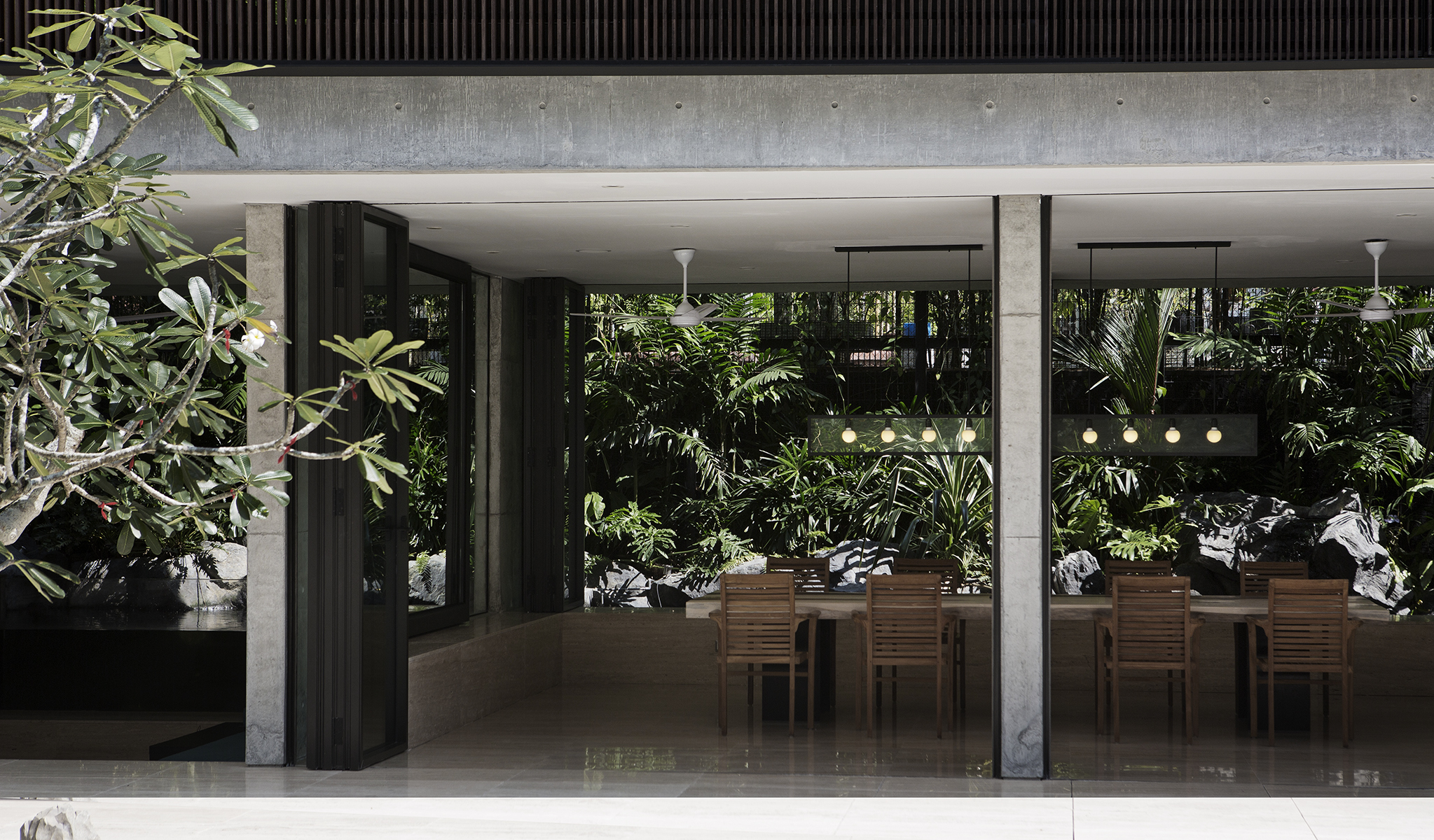 The Courtyard House balances periphery and core, open and private, and lush tropical foliage acts as a buffer to neighbours and a temper to the western sun.