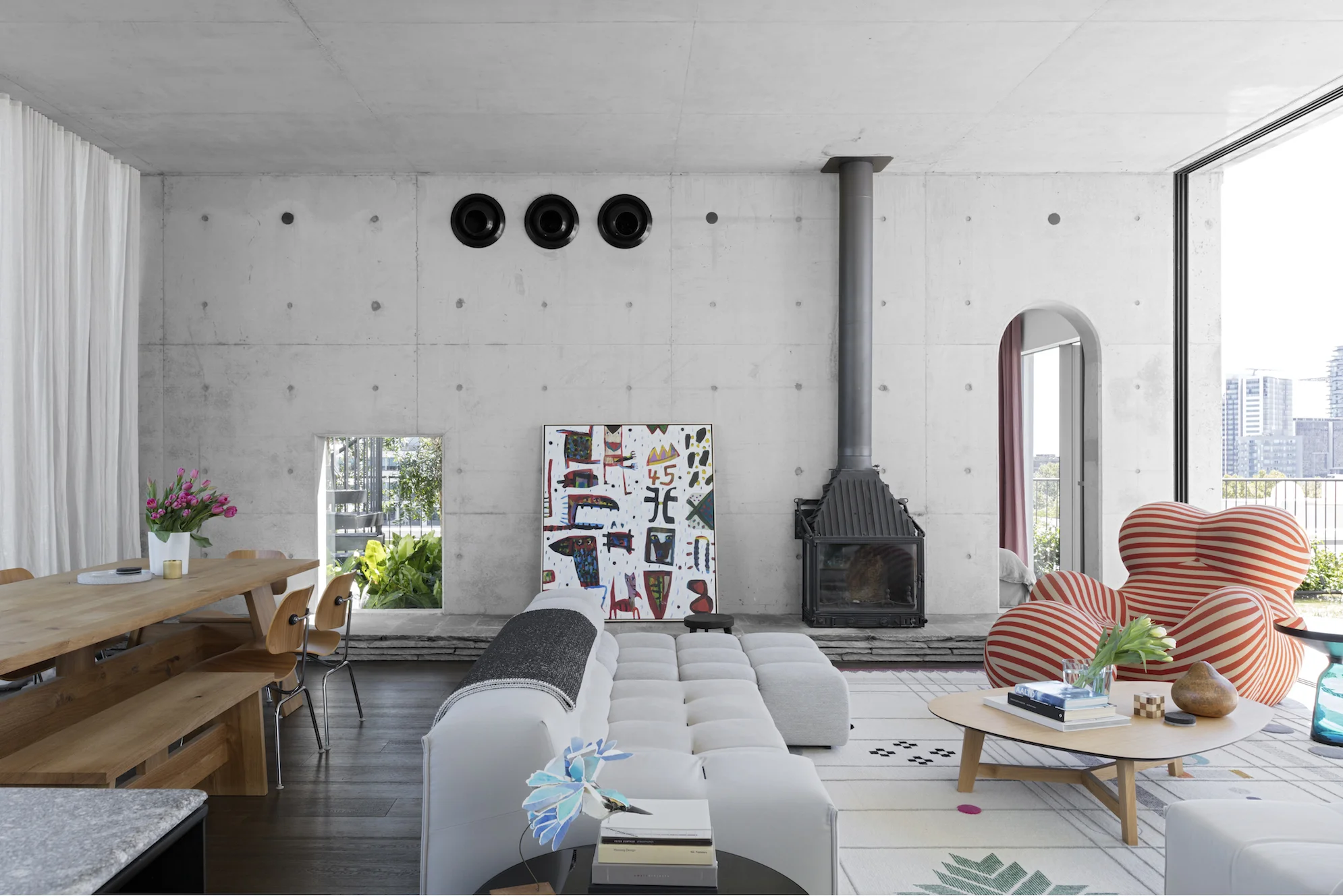 A window to the world positioned to view the University of Sydney's clock tower and the Blue Mountains beyond. Key pieces in the furniture collection include UP 2000 by Gaetano Pesce and Tufty Time by Patricia Urquiola for B&B Italia. Photography by Felix Forest. 