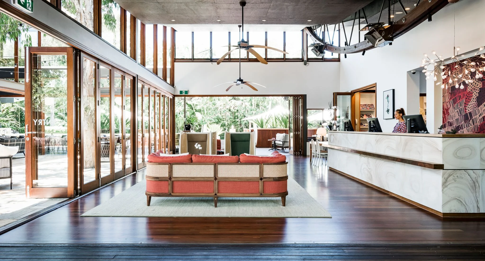 Reinvigorating the reception area involved the design of a bespoke counter made of sandstone, copper and timber joinery, and the selection of furniture pieces by GTV, including the Promenade sofa and Hideout armchairs. Photo Michael Wee. 