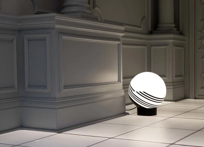 Op Art patterns were the inspiration for this modern table light made from powder-coated spun steel and blown from opaque glass, 