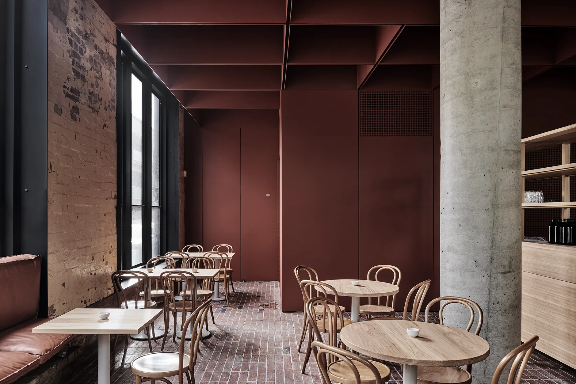 Leather, brick, concrete, timber and steel, painted in an earthy red oxide, provide a material palette that is stripped back to the essential elements. Photo Tom Blachford. 
