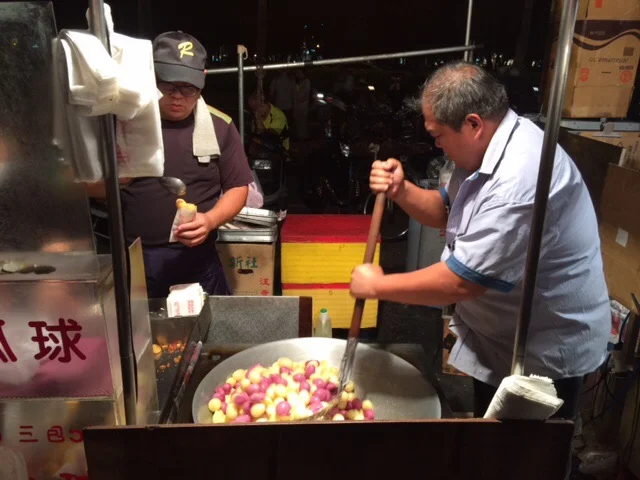 We loved how inexpensive street food is in Taiwan. We mostly ate out, which was cheaper than grocery shopping. Our favorite place to go was a night market just down the street from our apartment. Here, a vendor makes fried sweet potato balls — delish!