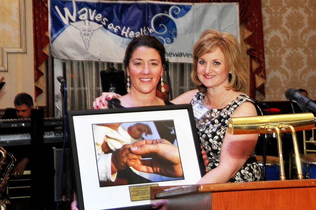 Cecilia bara-saharig accepting her award from kelly healy-kreis.
