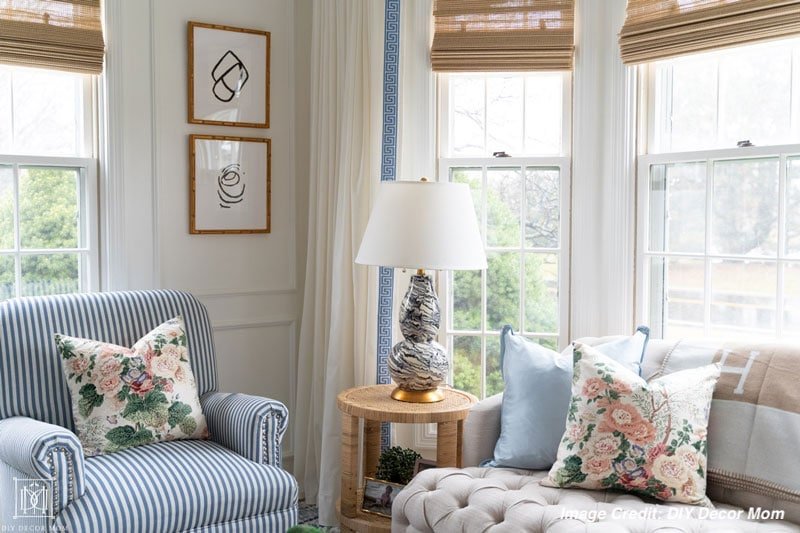 white-living-room-with-floral-chintz-pillows-and-greek-key-trim-curtains.jpeg