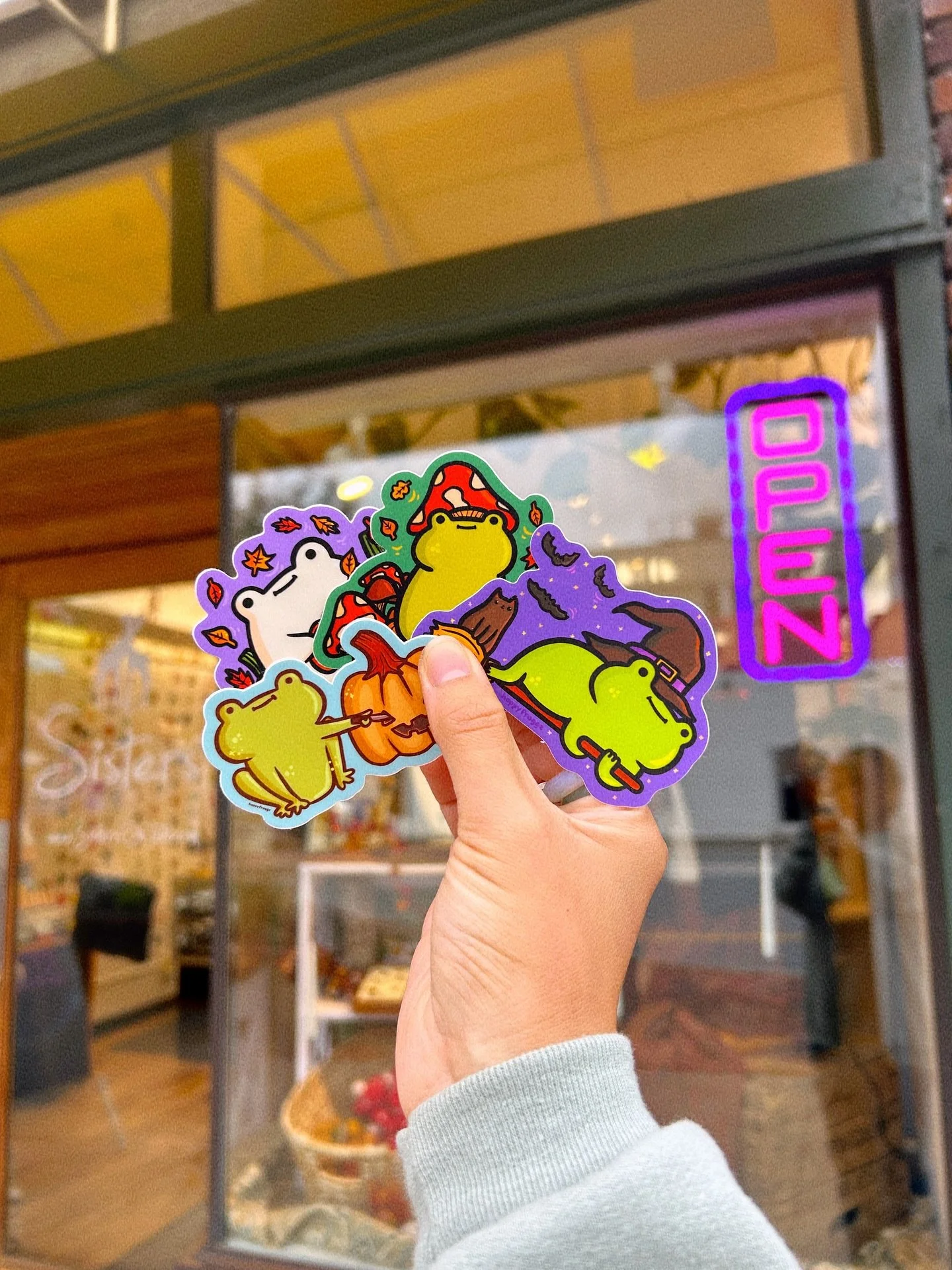 We&rsquo;re excited to carry a few styles of @hoppyfroggz stickers! Each whimsical, colorful frog is designed by local artist Mynnie, a familiar face here at Sisters! 🐸 Come pick one up before they&rsquo;re gone!