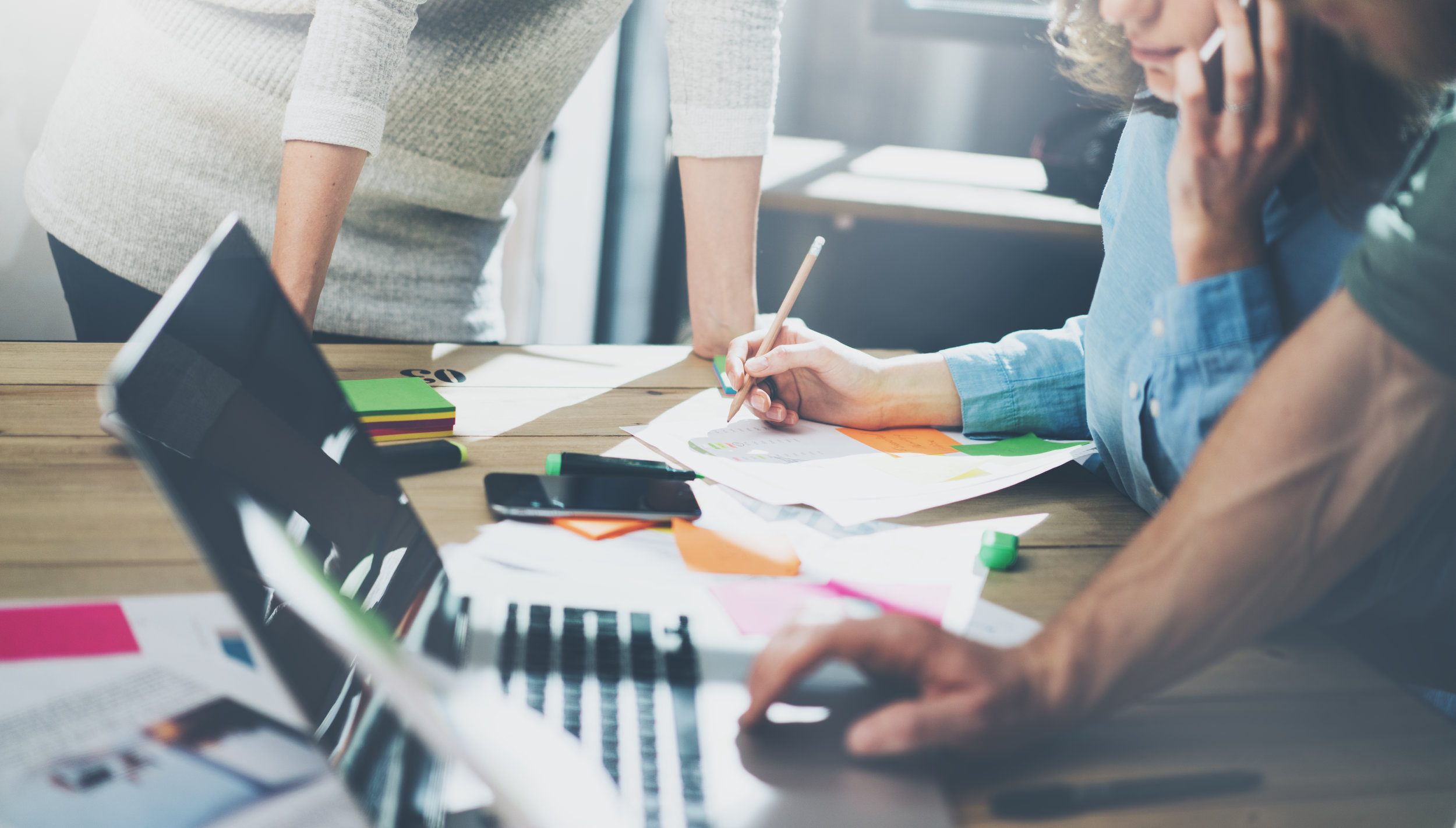 Accounting business meeting concept. Photo young businessman crew working with new startup project in modern loft. Generic design notebook on wood table, talking smartphone. Horizontal, film effect