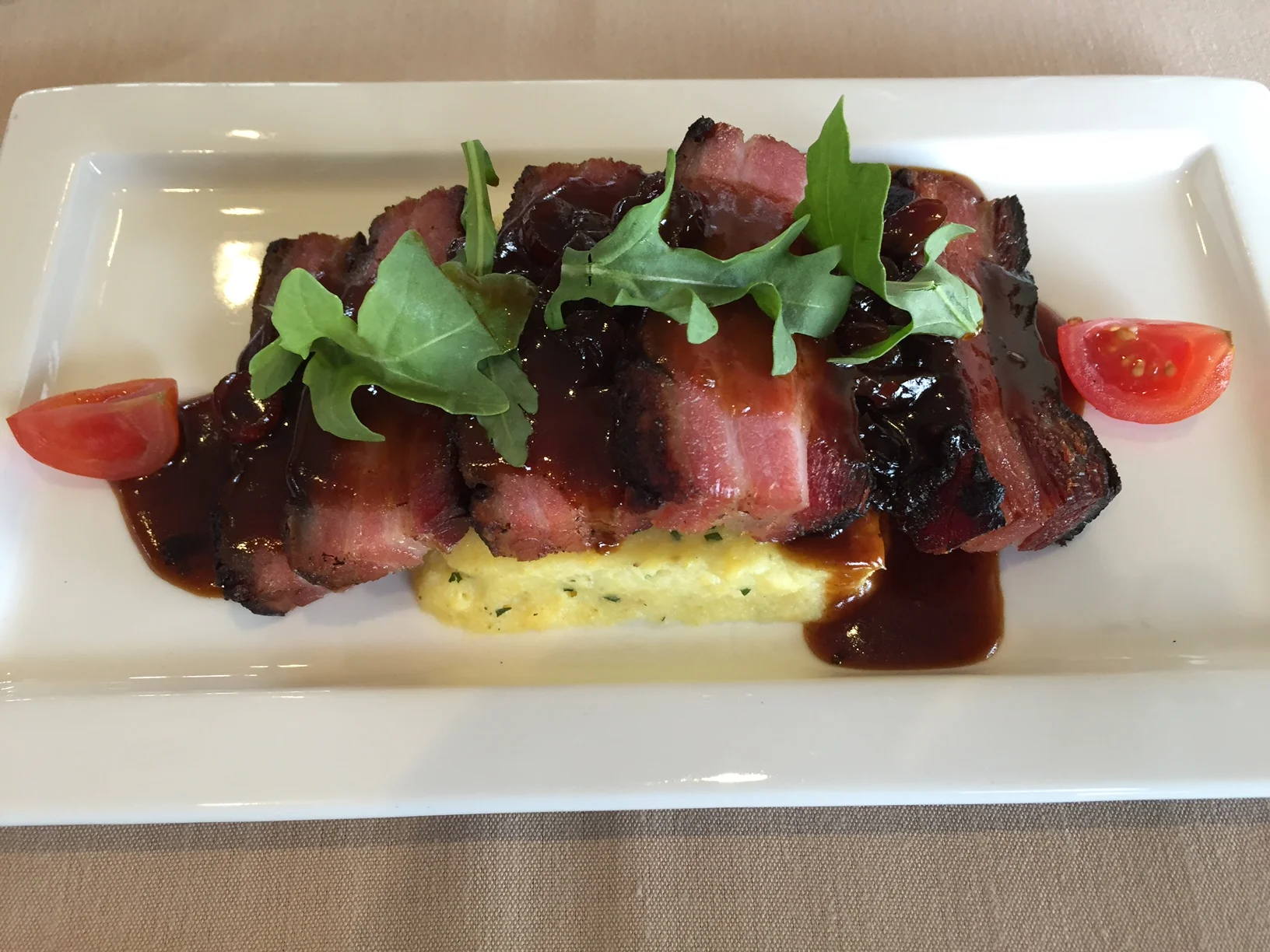 Braised Pork Belly w. Creamy Polenta, Cranberry Sauce and Arugula